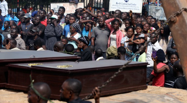 People react as a truck carries the coffins of people killed by the Fulani herdsmen, in Makurdi, Nigeria.