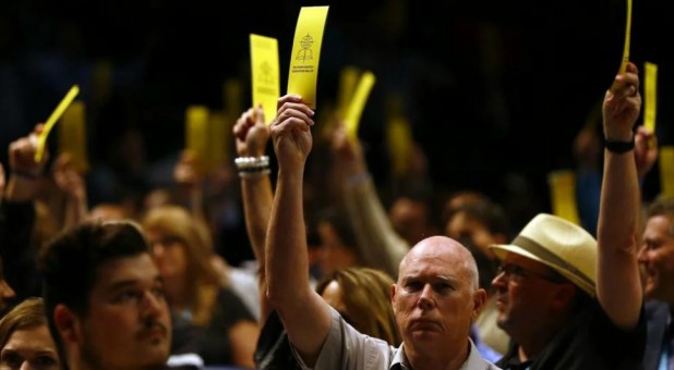 Messengers vote in favor on the amendment of SBC Constitution Article III, Section 1, on sexual abuse during the annual meeting of the Southern Baptist Convention.