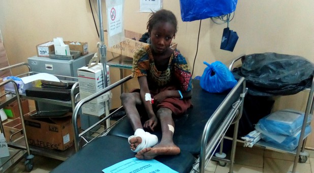 An injured girl sits inside a hospital after a suspected Boko Haram attack on the edge of Maiduguri's inner city, Nigeria.