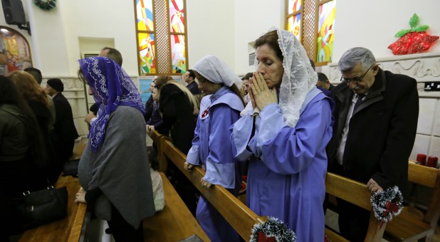 Iraqi Christians pray during a mass on Christmas at St George Chaldean Catholic Church in Baghdad, Iraq.