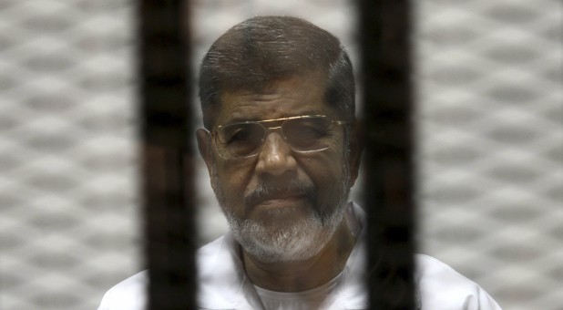 Ousted Egyptian President Mohamed Mursi is seen behind bars during his trial at a court in Cairo May 8, 2014.