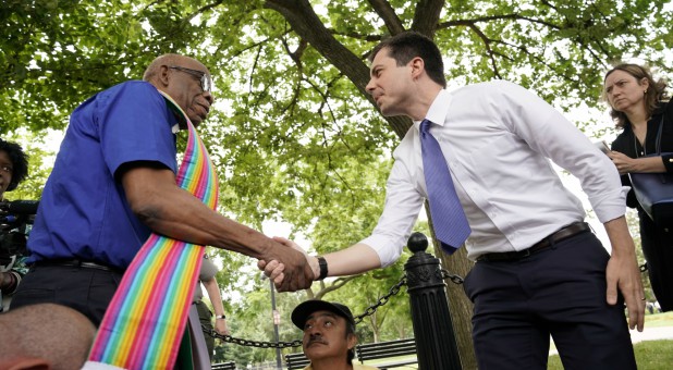 2020 Democratic U.S. presidential candidate South Bend Mayor Pete Buttigieg greets an activist as he attends a rally in protest against the Trump administration.