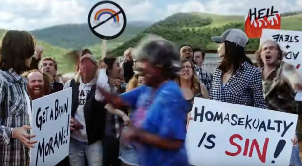 Protesters hold signs in the new Taylor Swift video.