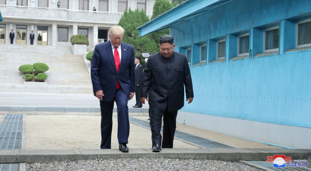 U.S. President Donald Trump and North Korean leader Kim Jong Un cross over a military demarcation line at the demilitarized zone (DMZ) separating the two Koreas, in Panmunjom, South Korea.