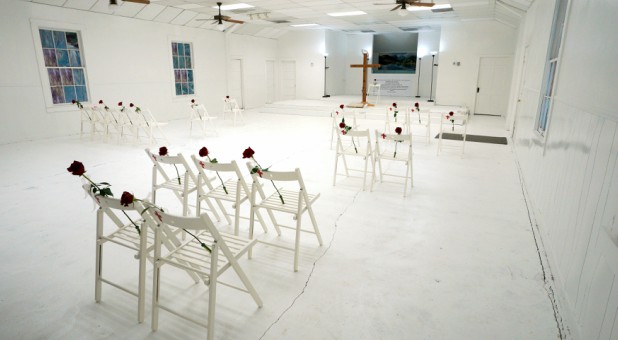 The sanctuary where the shooting took place with chairs placed in honor and memory, each victim's name written in gold across the back