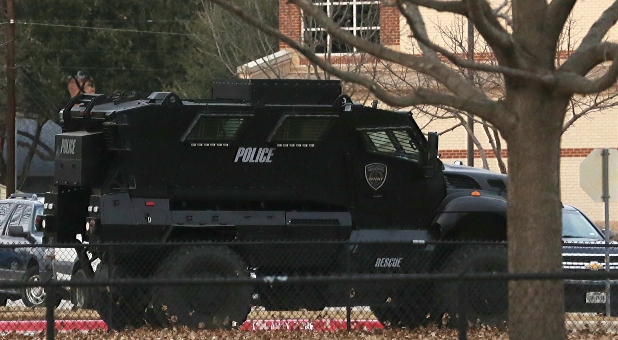 A law enforcement vehicle is parked at a school in the area where a man took people hostage at a synagogue during services that were being streamed live, in Colleyville, Texas, U.S. January 15, 2022.
