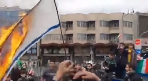 Israel''s flag burns as part of Iran's celebration of its Muslim Revolution.