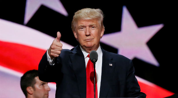 2022 12 Reuters Trump Flag Thumbs Up