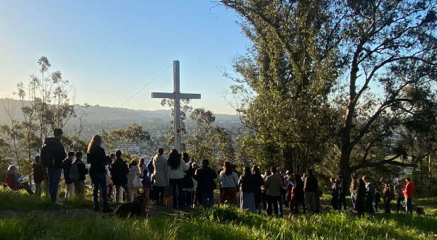 Supporters rally around the Albany Hill cross.