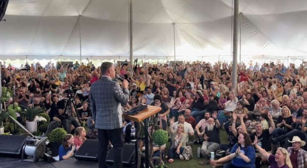 Filled revival tent at Global Vision Bible Church.