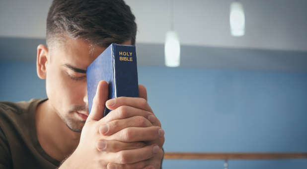 Man praying with Bible