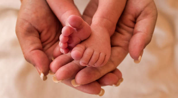 Newborn baby in mother's hands