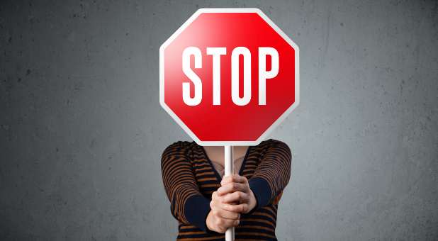 woman holding stop sign