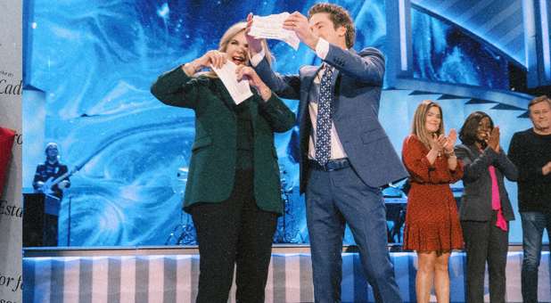 Joel and Victoria Osteen tearing up loan documents.
