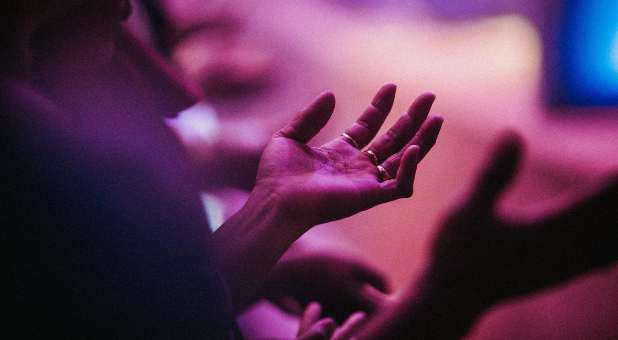 Hands raised in worship.