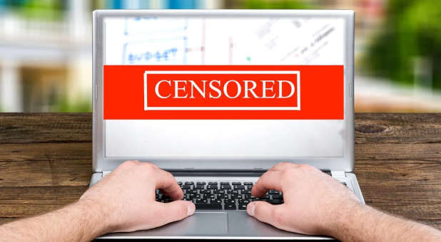 A website censored on a laptop.