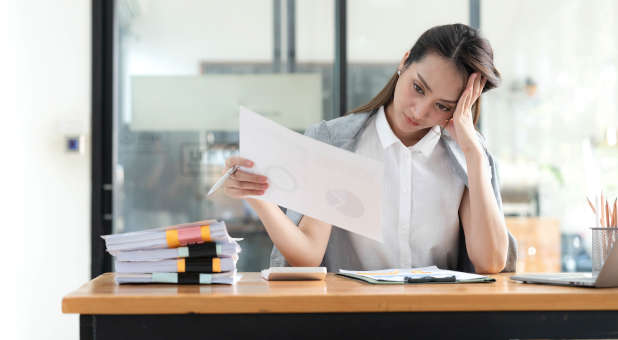 A woman stressed from work overload.
