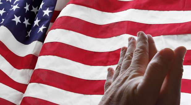 praying hands over American flag