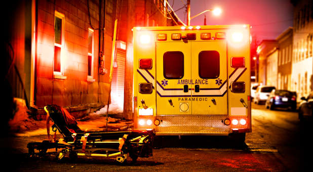 Ambulance and stretcher at night.