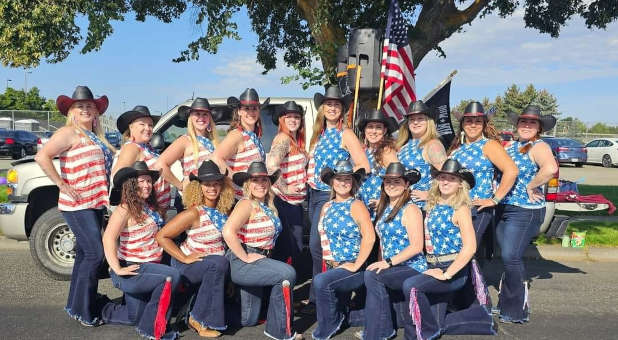 The Borderline dance team in their patriotic attire with flag.