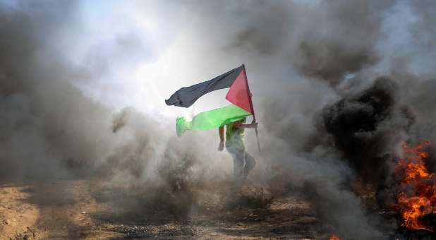 Pro-Palestine flag amid flames of war