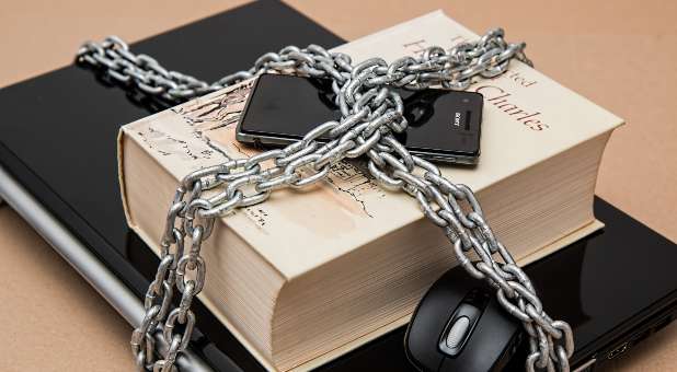 phone, book, mouse and laptop in chains