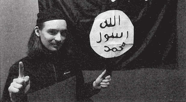 Idaho teen supporting ISIS with flag in background.